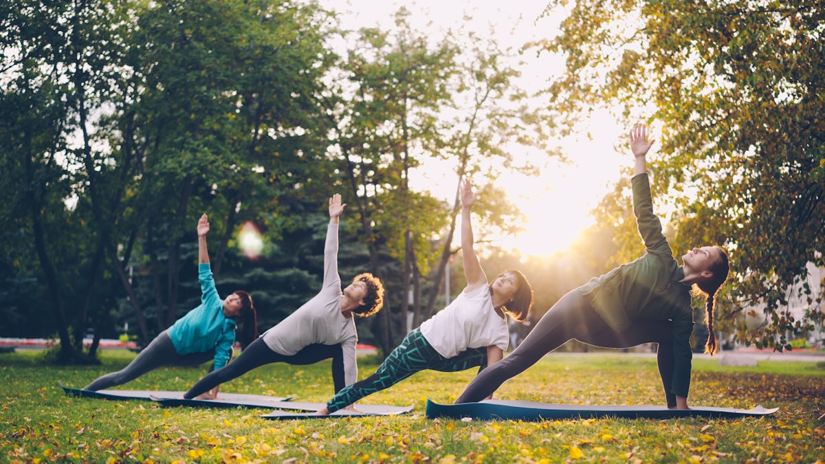 Individual practicing balance poses outdoors